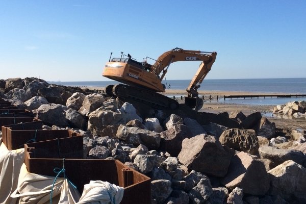 An excavator on the rocks at Rossal beach